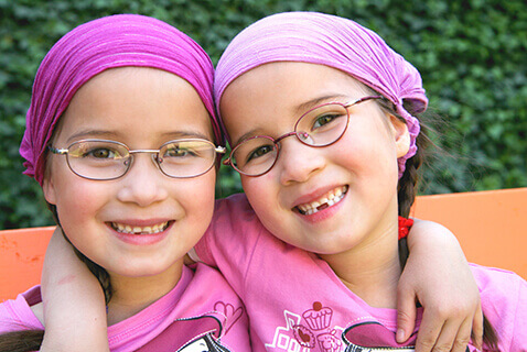 Twin young girls wearing glasses